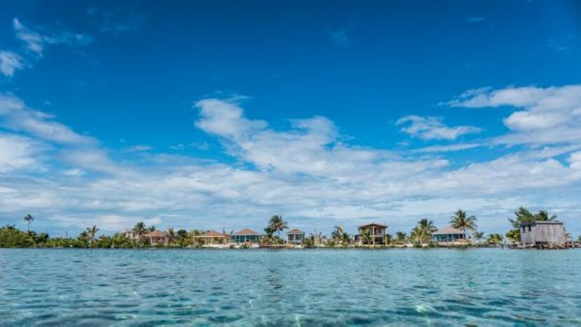 
Cabanas line the shore of an island on Glover’s Reef in Belize. Glover’s is an atoll, a...