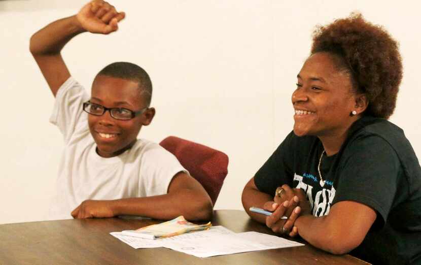 
Sylance Holmes, 12, and Desiree Calton take part during a meeting of the Tri-Cities branch...