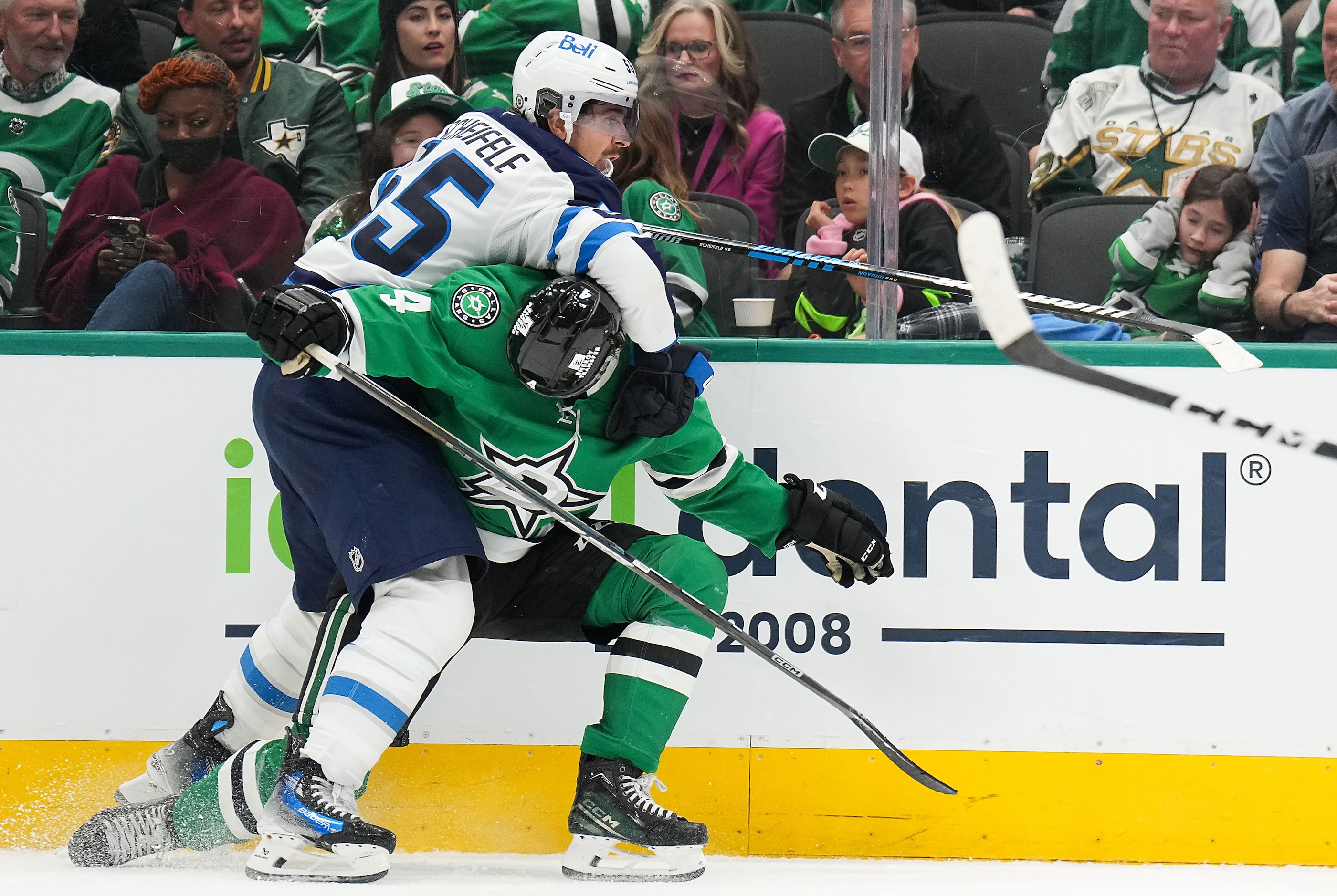 Dallas Stars defenseman Miro Heiskanen (4) gets tied up along the boards with Winnipeg Jets...