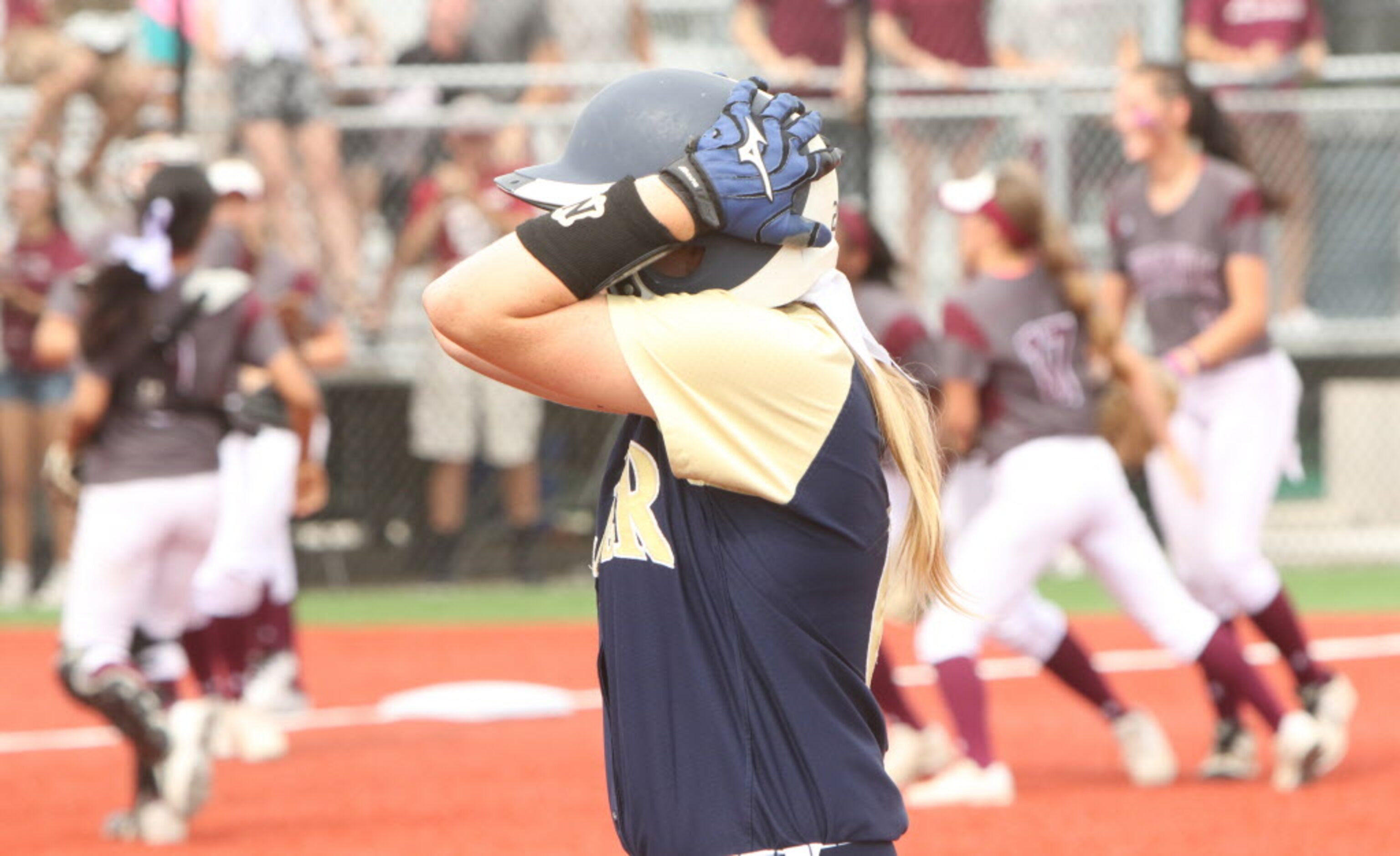 Keller's Kasey Simpson (6) stands in shock as Lewisville players celebrate after a Keller...