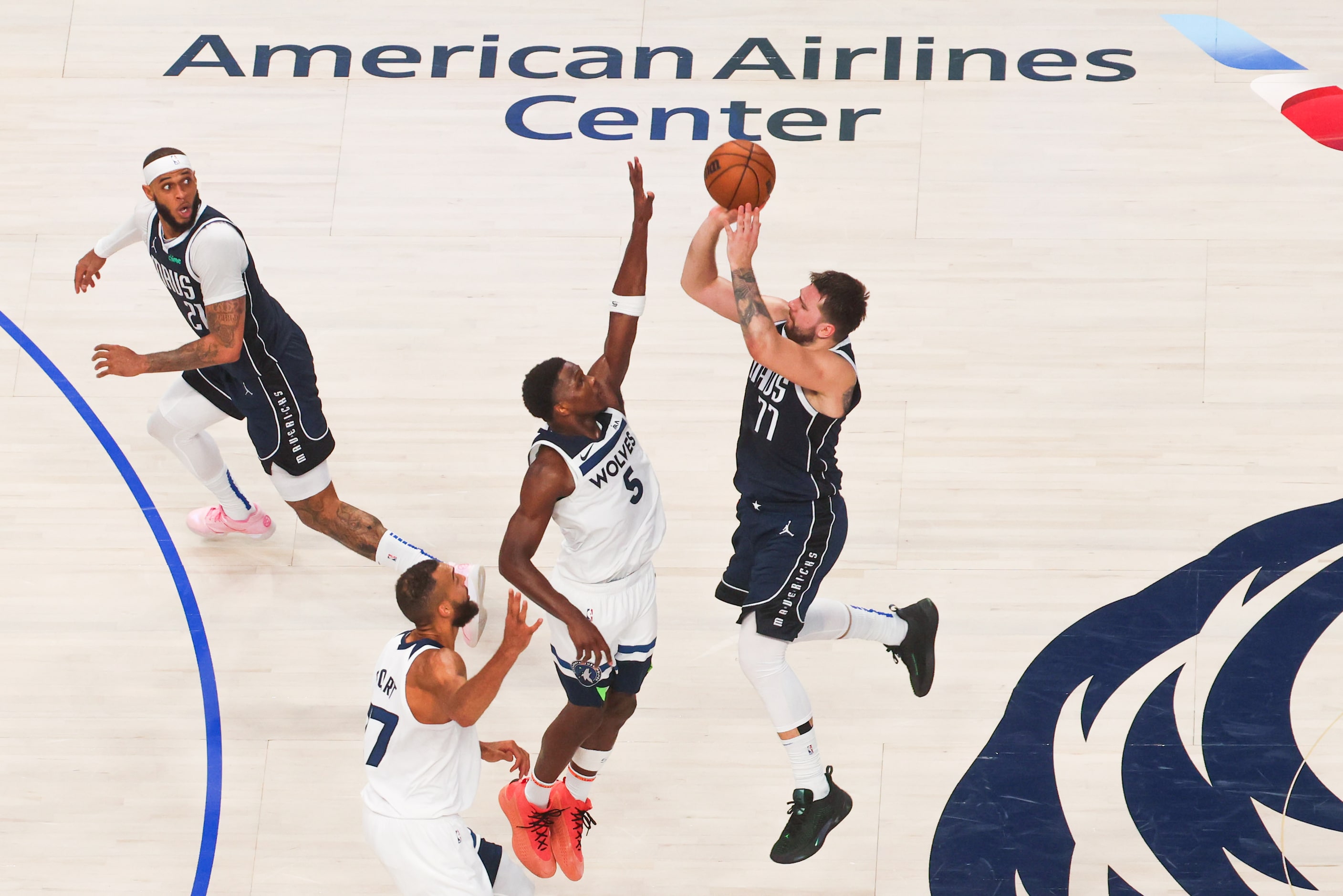 Dallas Mavericks guard Luka Doncic (77) shoots over Minnesota Timberwolves guard Anthony...