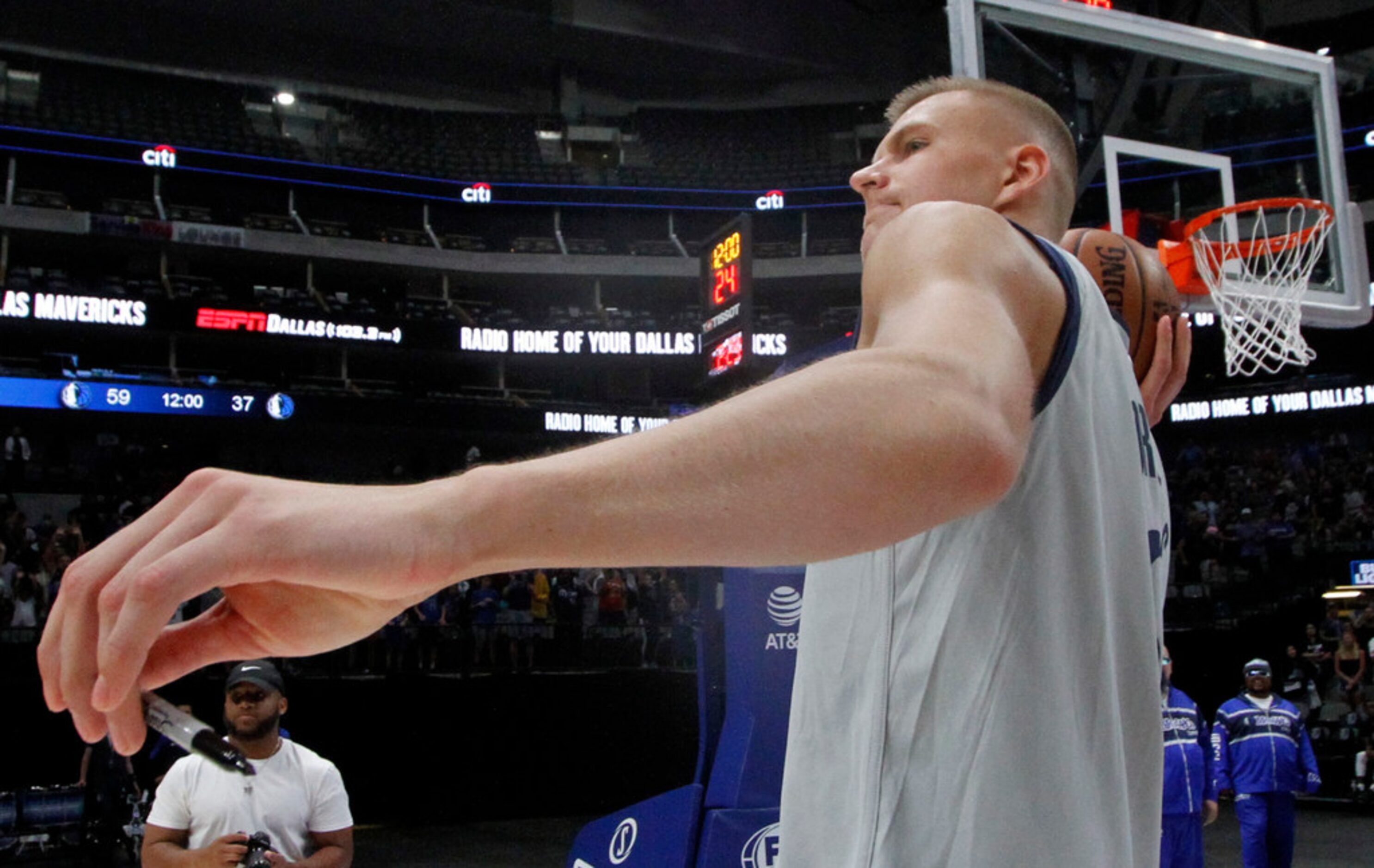 Dallas Mavericks center Kristaps Porzingis (6) prepares to launch an autographed basketball...