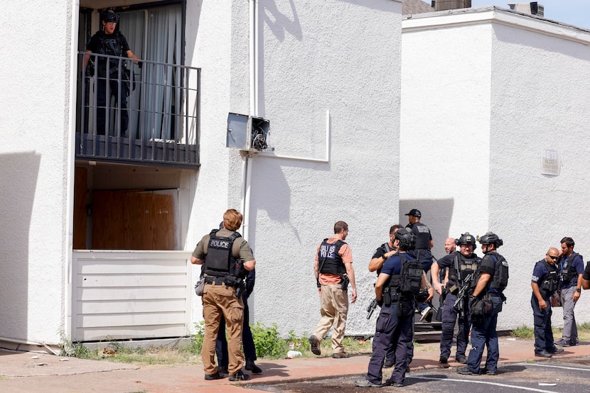 Dallas police SWAT officers debrief after executing a search warrant at the apartment of a...