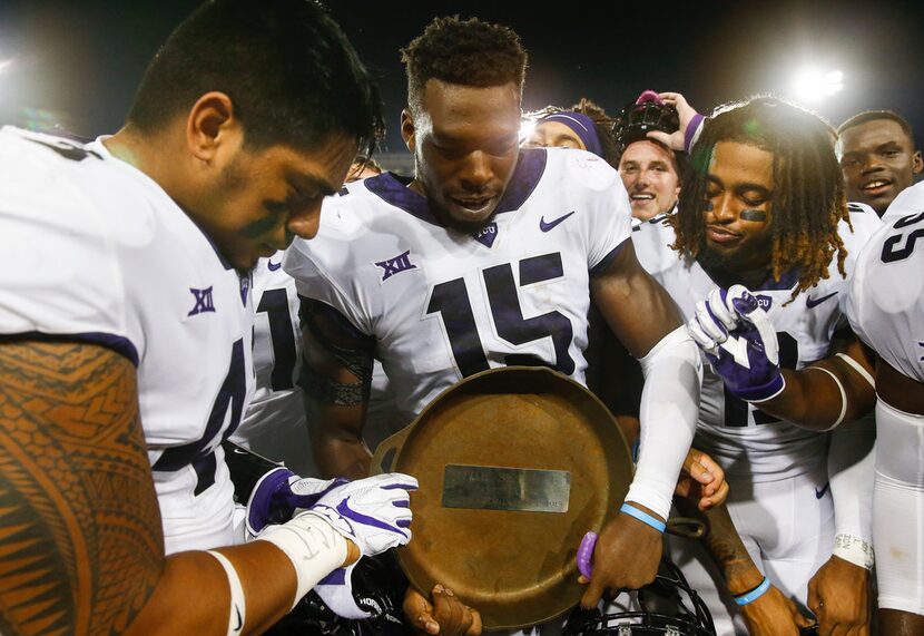 FILE - TCU players Ben Banogu (15), Izaih Filikitonga, left, and Jaelan Austin, right,...