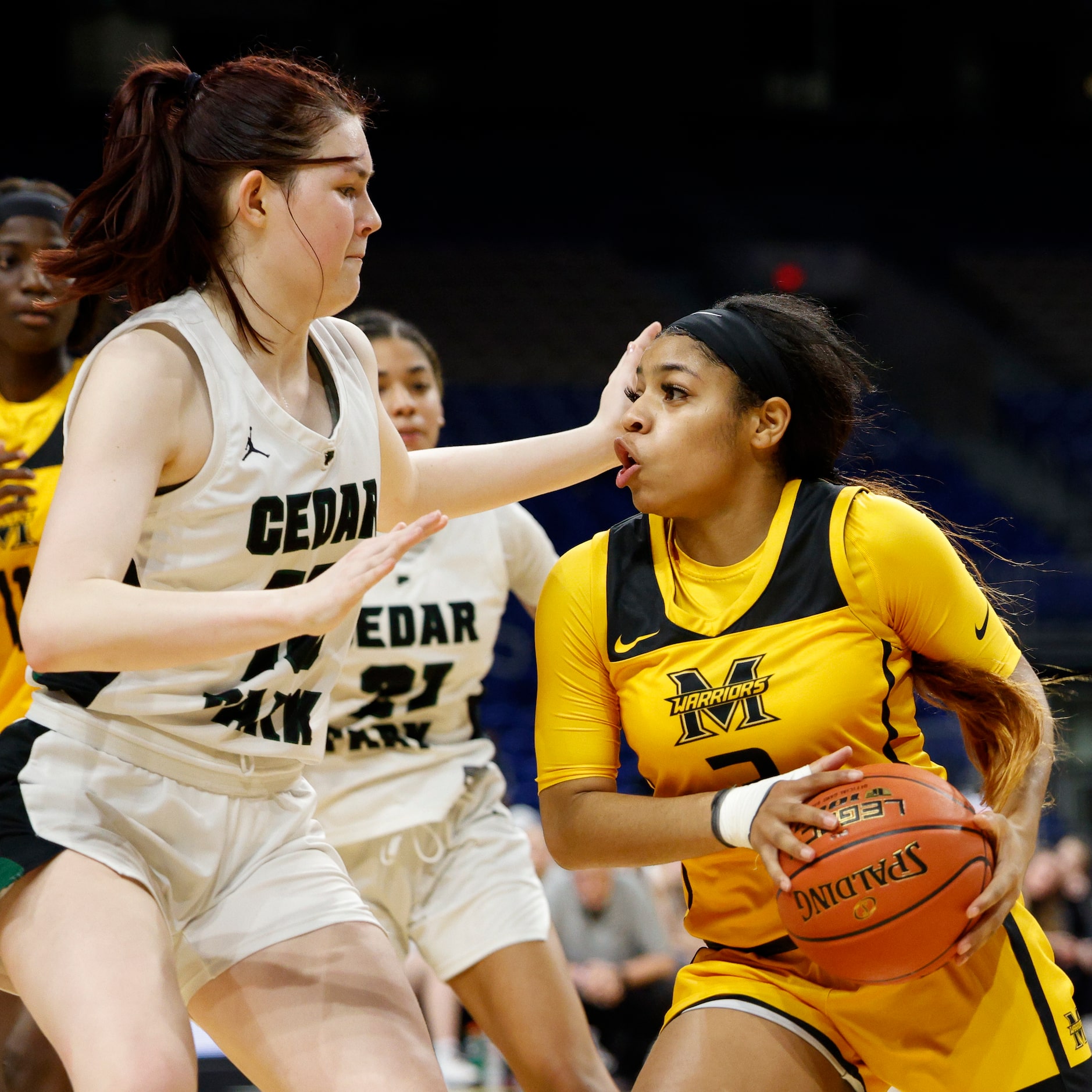 Cedar Park forward Elaine King (10) defends against a driving Frisco Memorial guard Wynter...