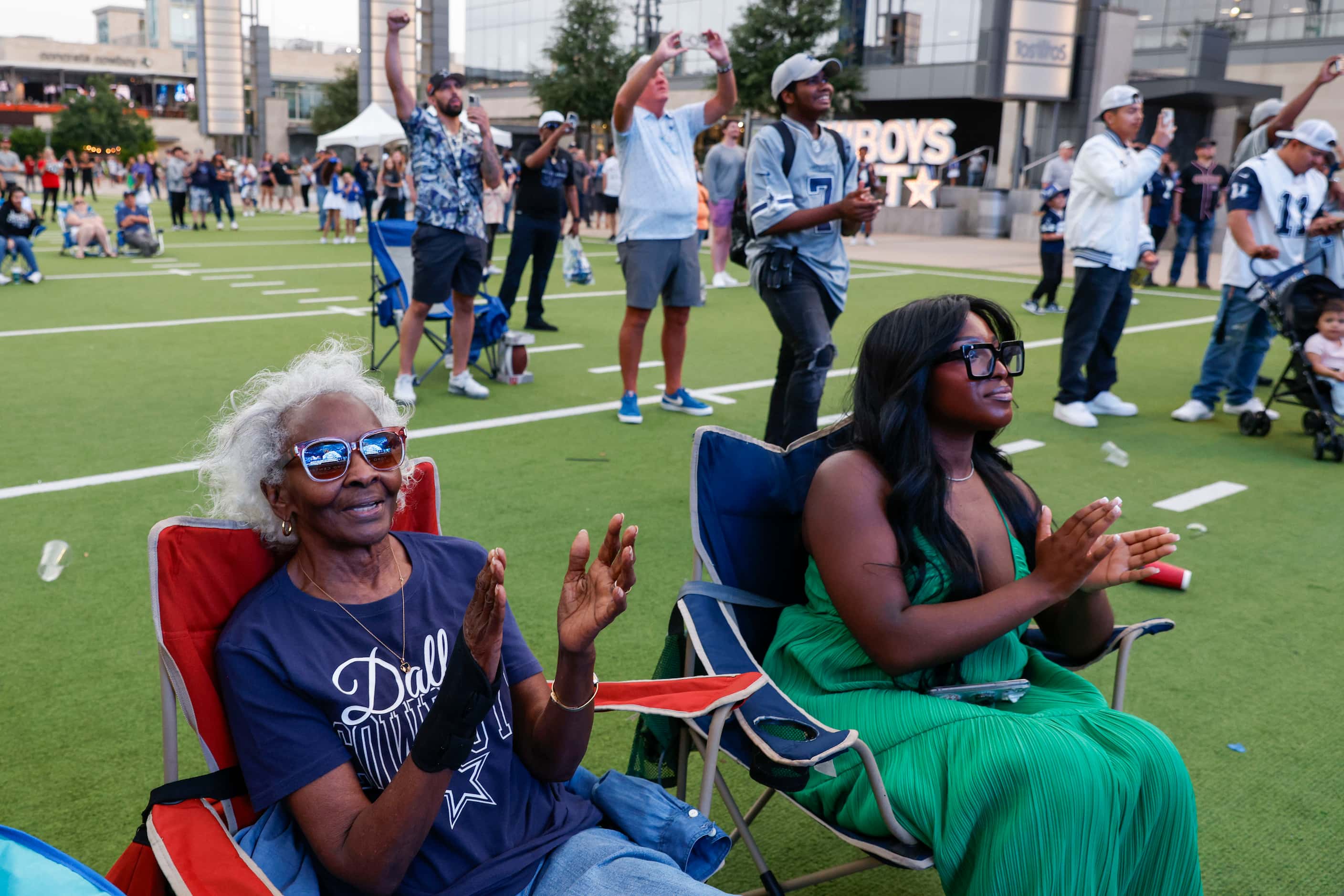 Bobbie, Richardson, (81), (left) and granddaughter, Heather Johnson, cheer followed by the...