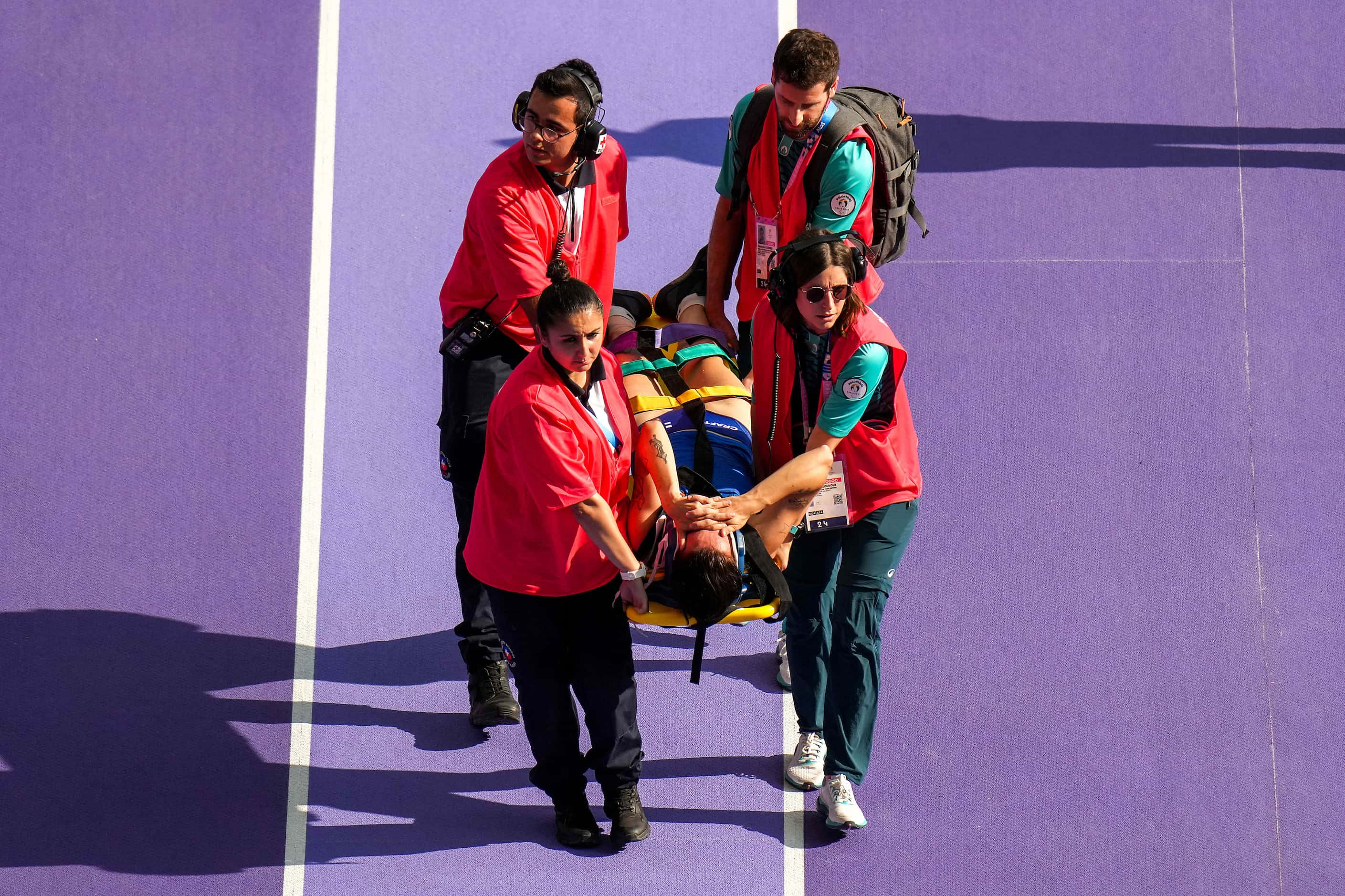 Senni Salminen of Finland is carried off the track after an injury before competing in...