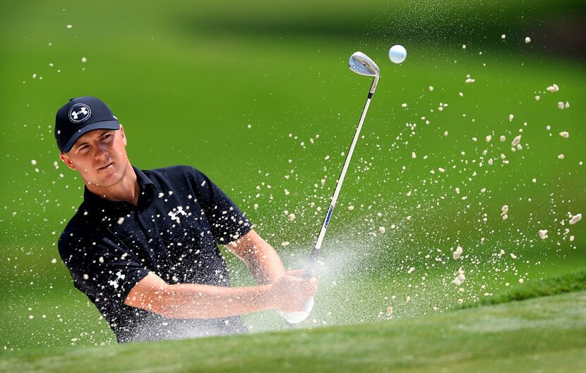 Jordan Spieth hits from a sand bunker along the 15th green during practice for the PGA...