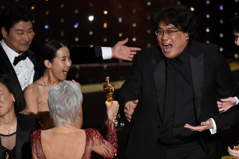 Bong Joon-ho, right, reacts as he is presented with the award for best picture for...