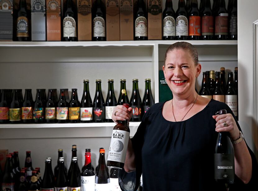 Shannon Birkes holds bottles of Rare Barrel's Map of the Moon and Side Project Brewing's...