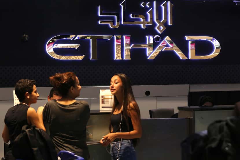 Passengers check into a flight at Abu Dhabi International Airport in Abu Dhabi, United Arab...