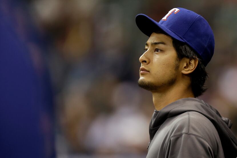 MILWAUKEE, WI - MAY 08: Yu Darvish #11 of the Texas Rangers watches the game from the edge...