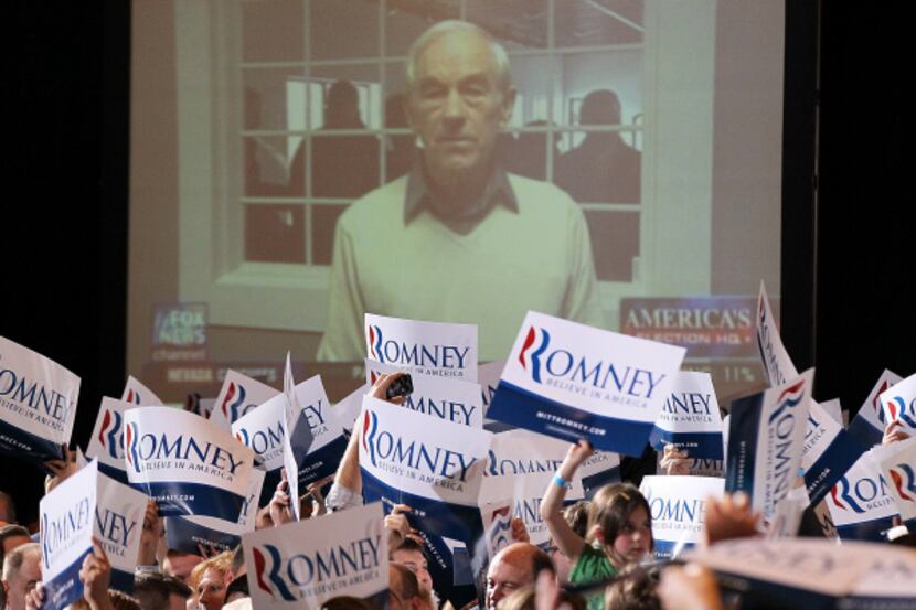 U.S. Rep. Ron Paul was on the big screen during a Nevada caucus party for Mitt Romney at a...