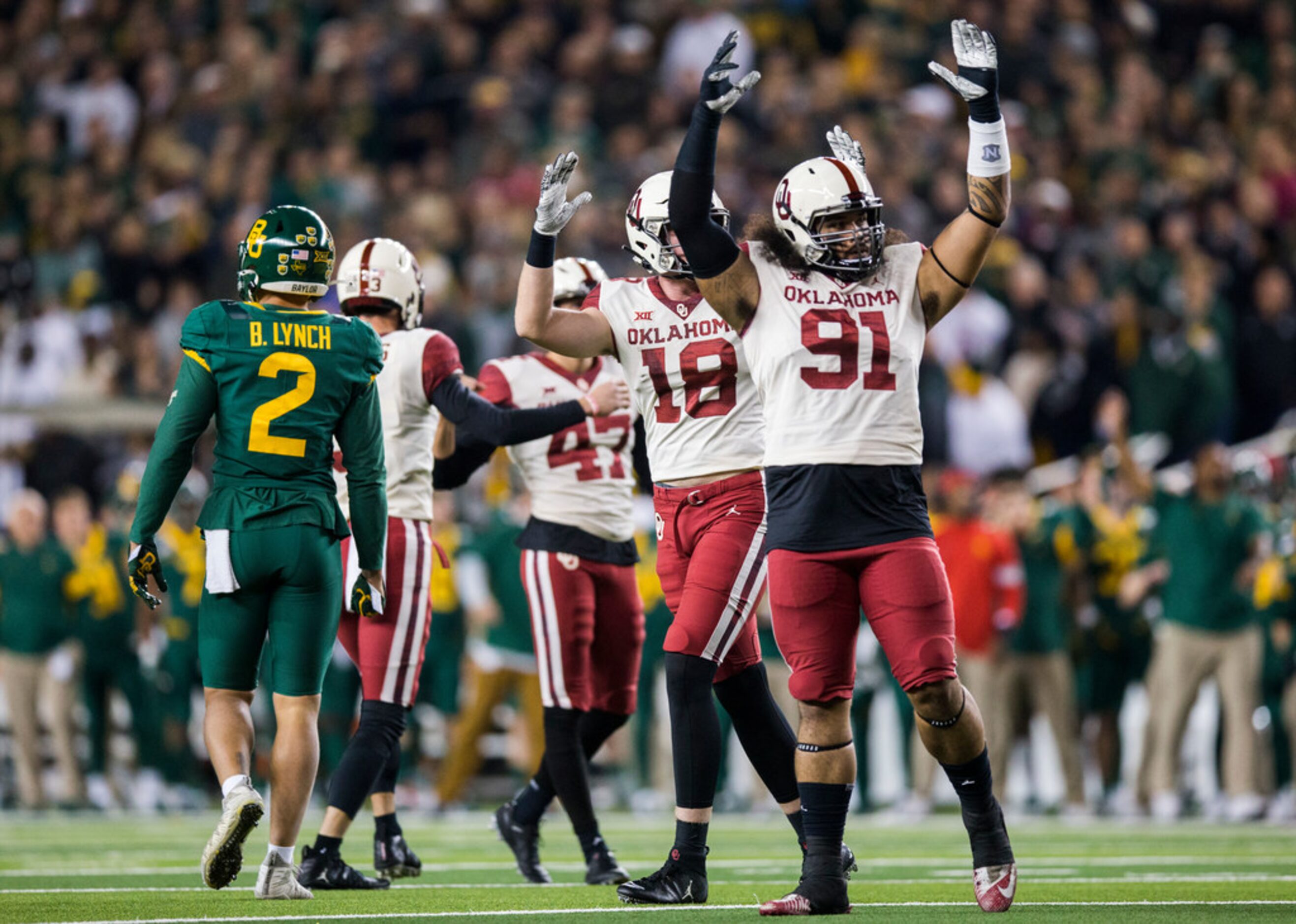 Oklahoma Sooners defensive lineman Dillon Faamatau (91) and other players celebrate after...