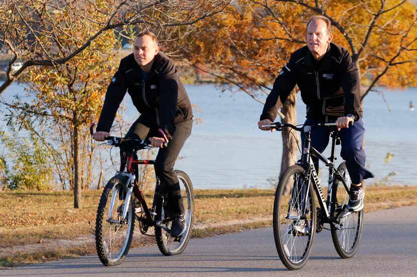 Michael Lambert, left, cycles with his father, Paul Lambert at White Rock Lake on Tuesday,...