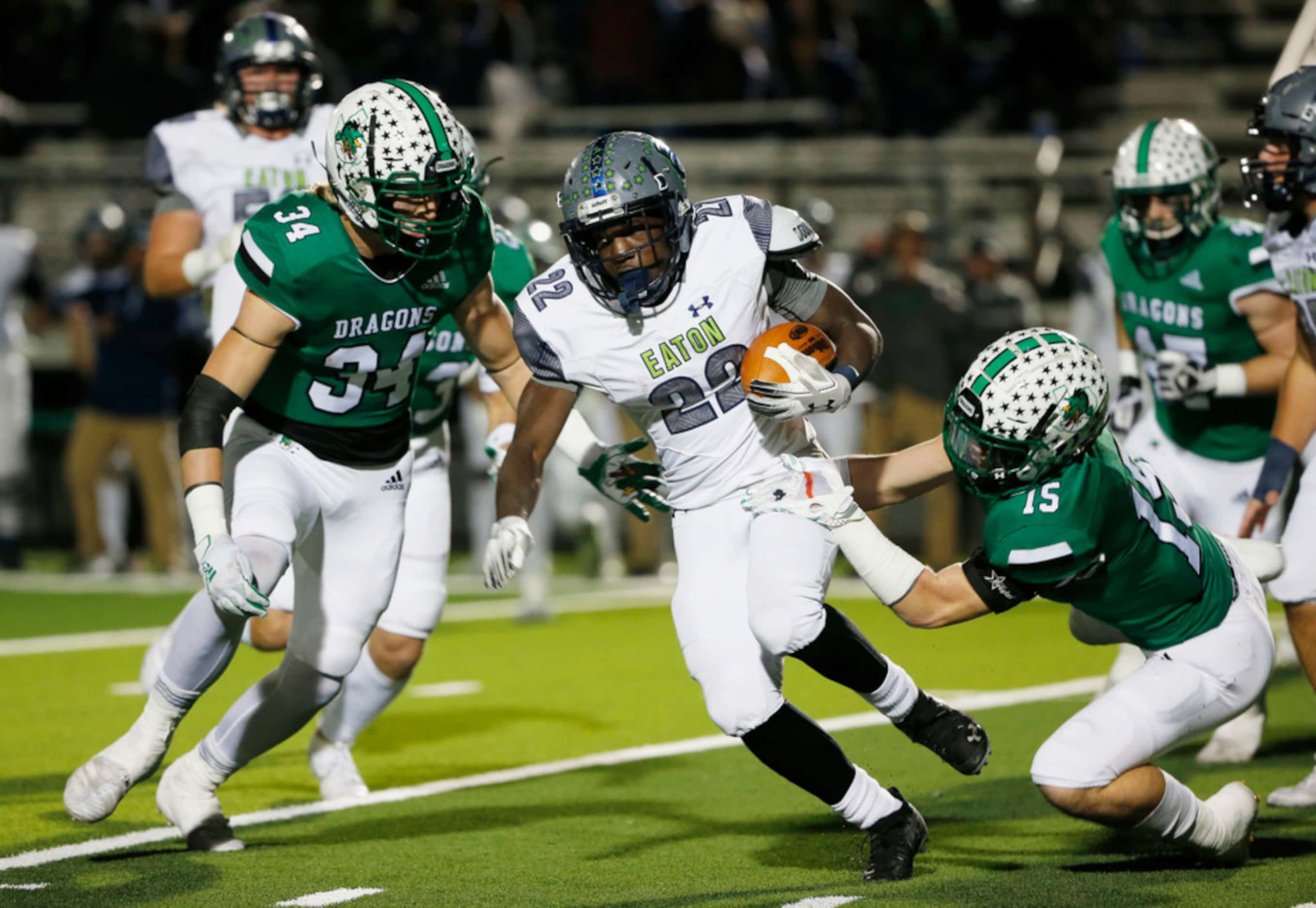 Southlake Carroll's Graham Faloona (34)and Brandon Howell (15) tackle Eaton's Jahbez Hawkins...