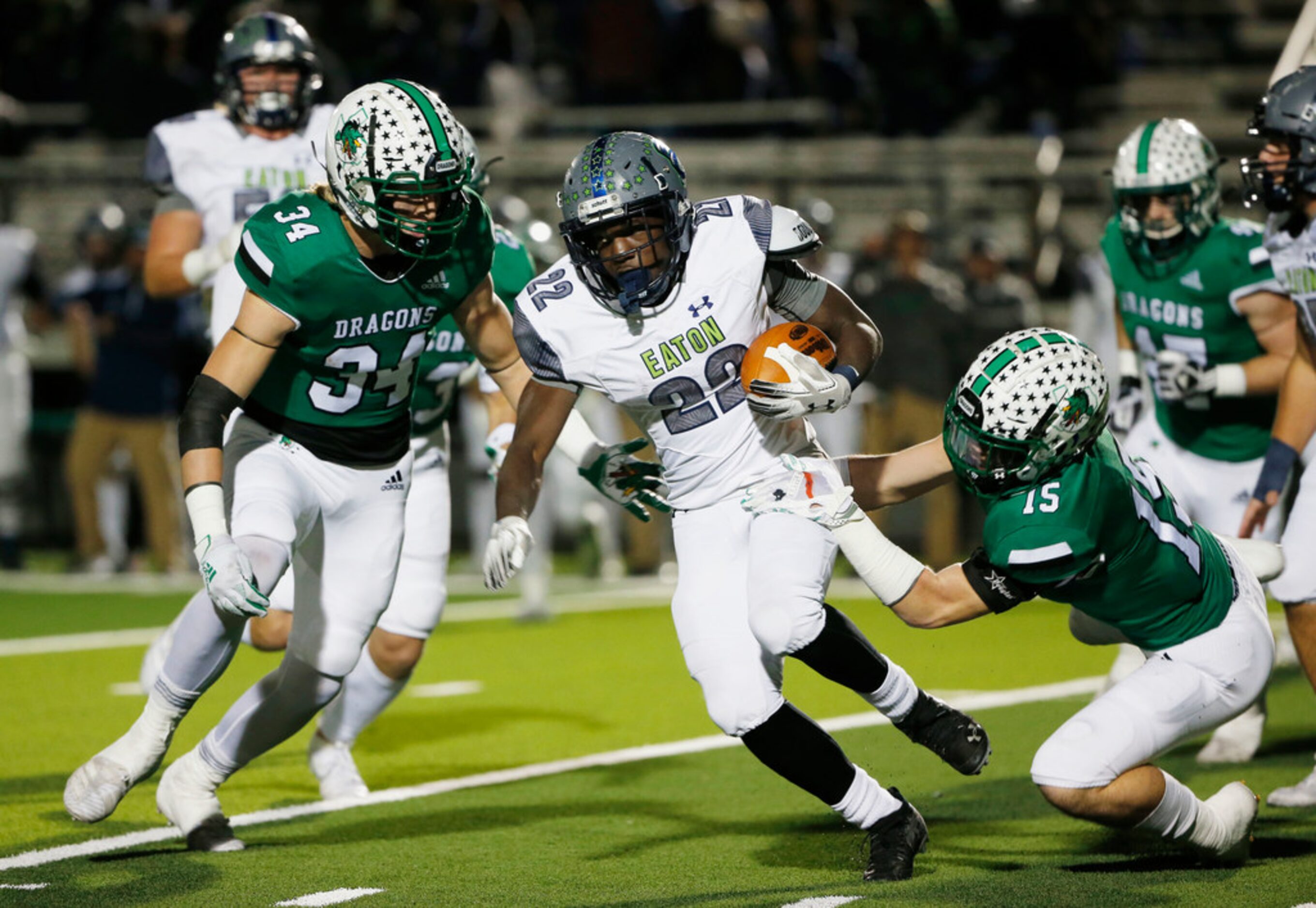 Southlake Carroll's Graham Faloona (34)and Brandon Howell (15) tackle Eaton's Jahbez Hawkins...