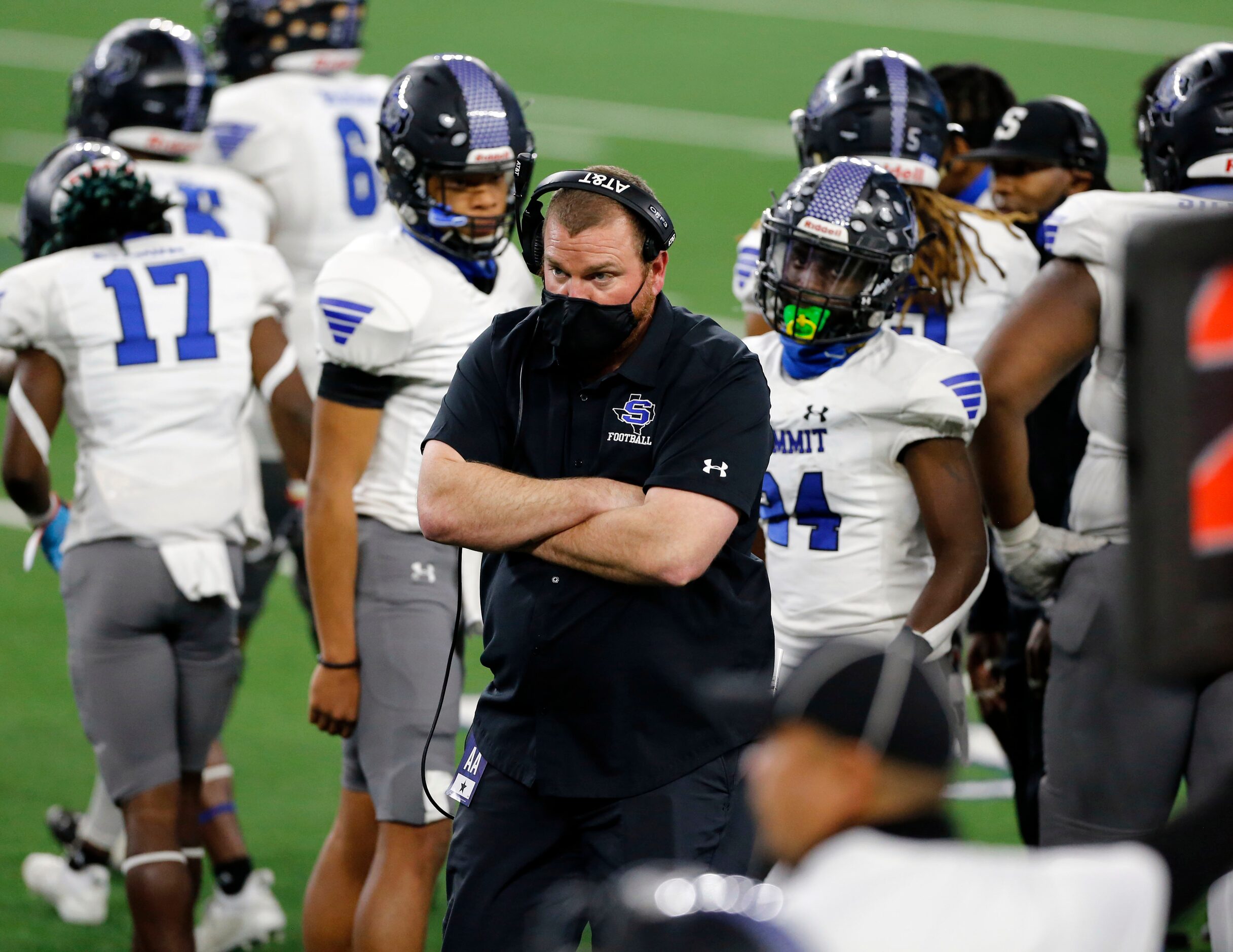 A Mansfield Summit coach stands arms folded as things unravel for the team during the second...