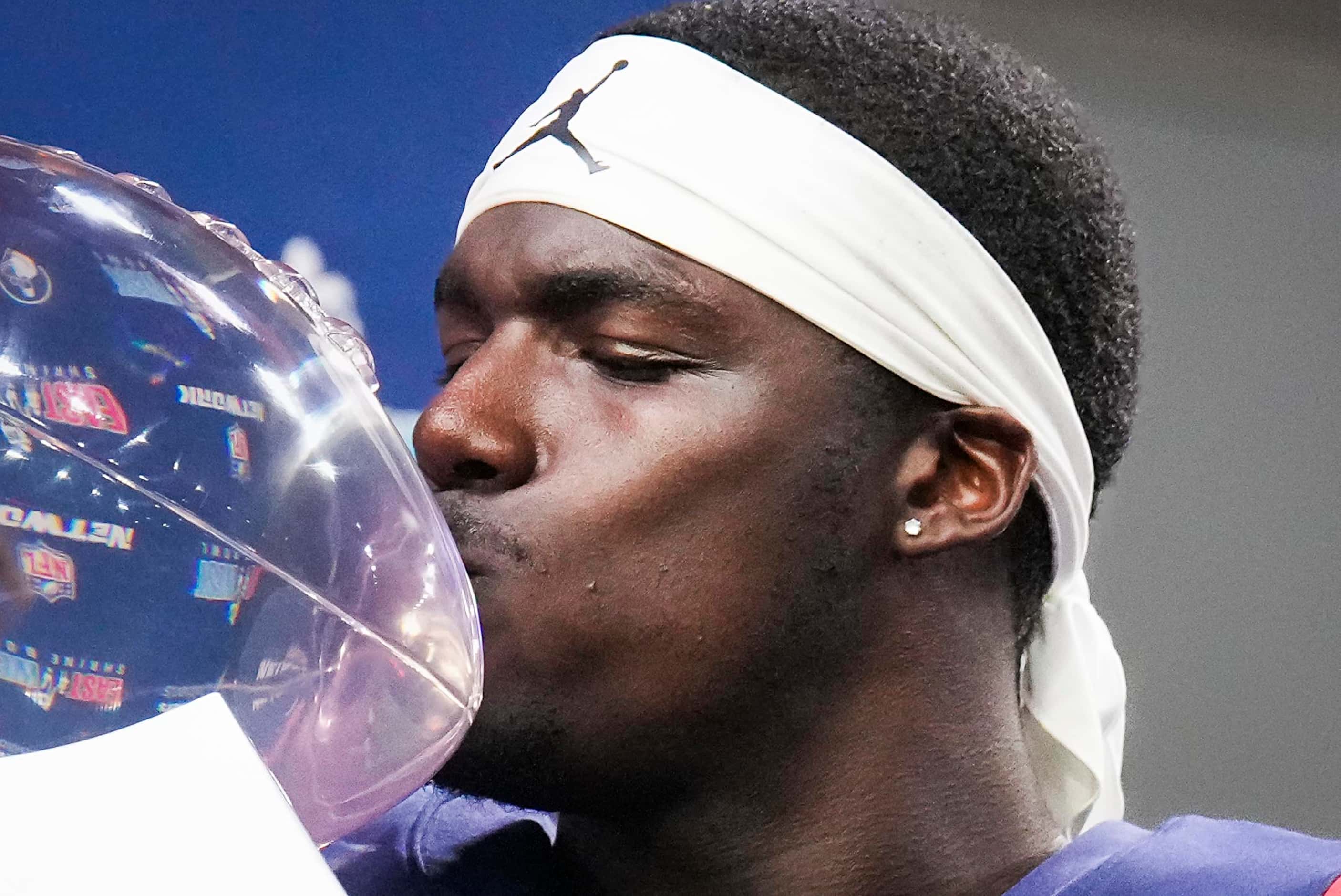 West defensive back Jarius Monroe of Tulane  kisses the game trophy after a victory in the...