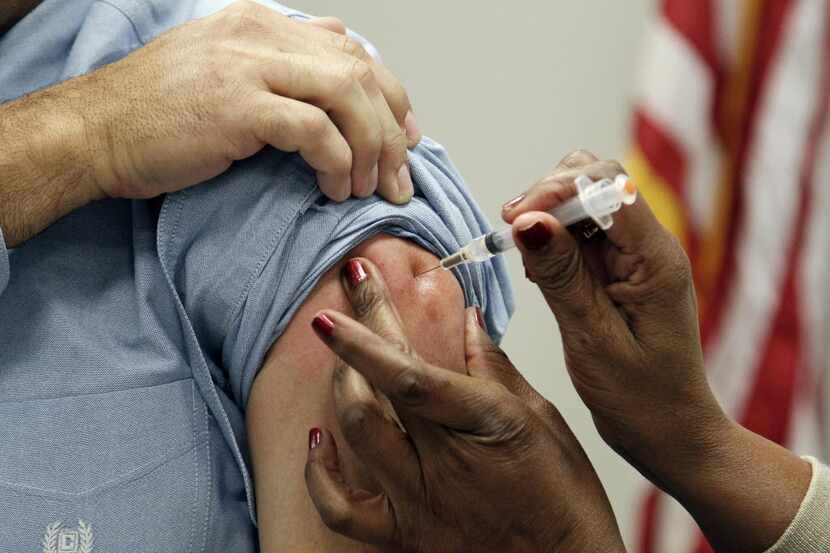 FILE - This Oct. 17, 2012 file photo shows a patient getting a flu shot in Jackson, Miss....