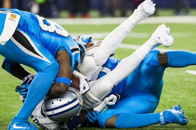 Dallas Cowboys running back Darren McFadden (20) is tackled by Carolina Panthers outside...