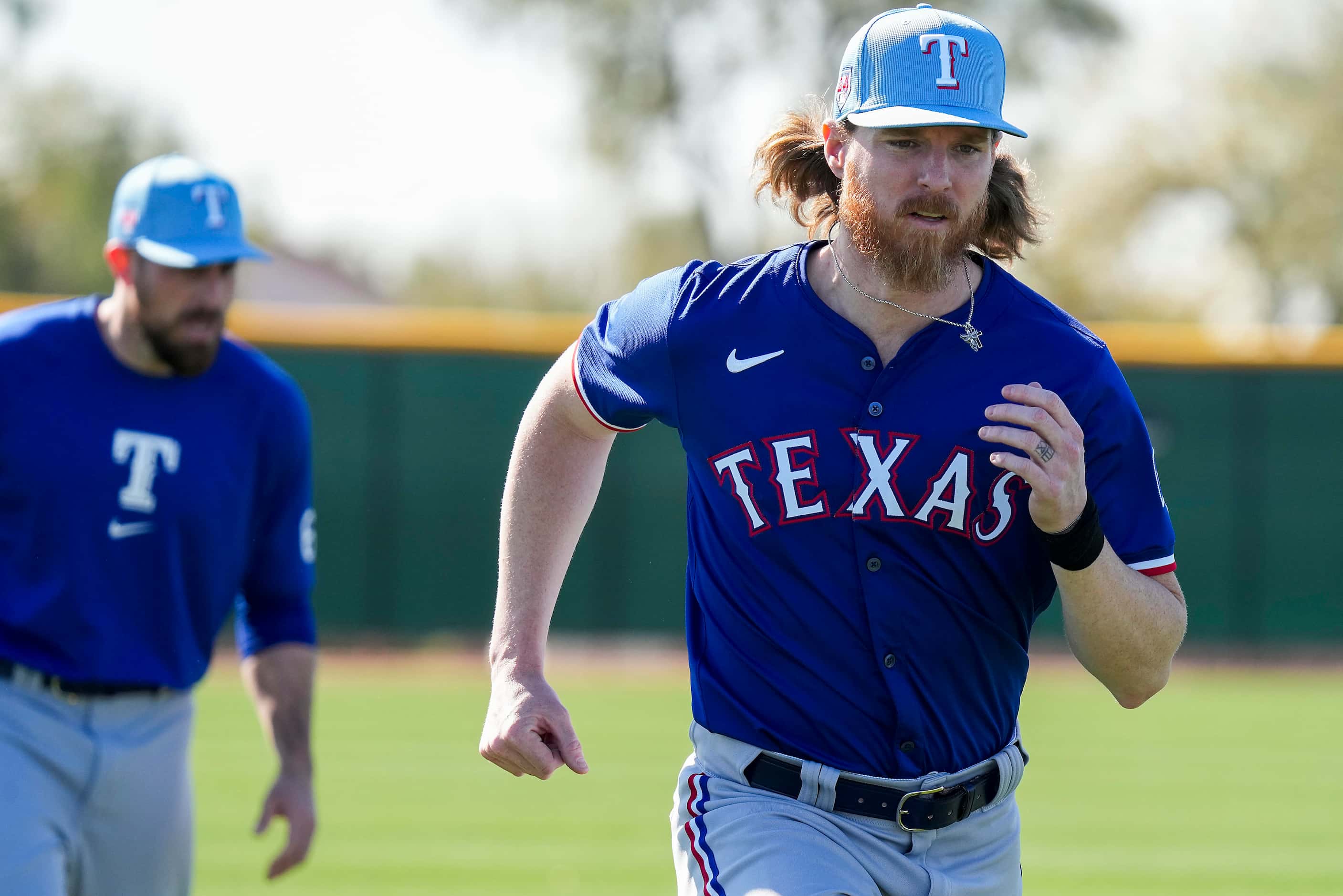 Texas Rangers pitcher Jon Gray runs with teammates Nathan Eovaldi during the first Spring...