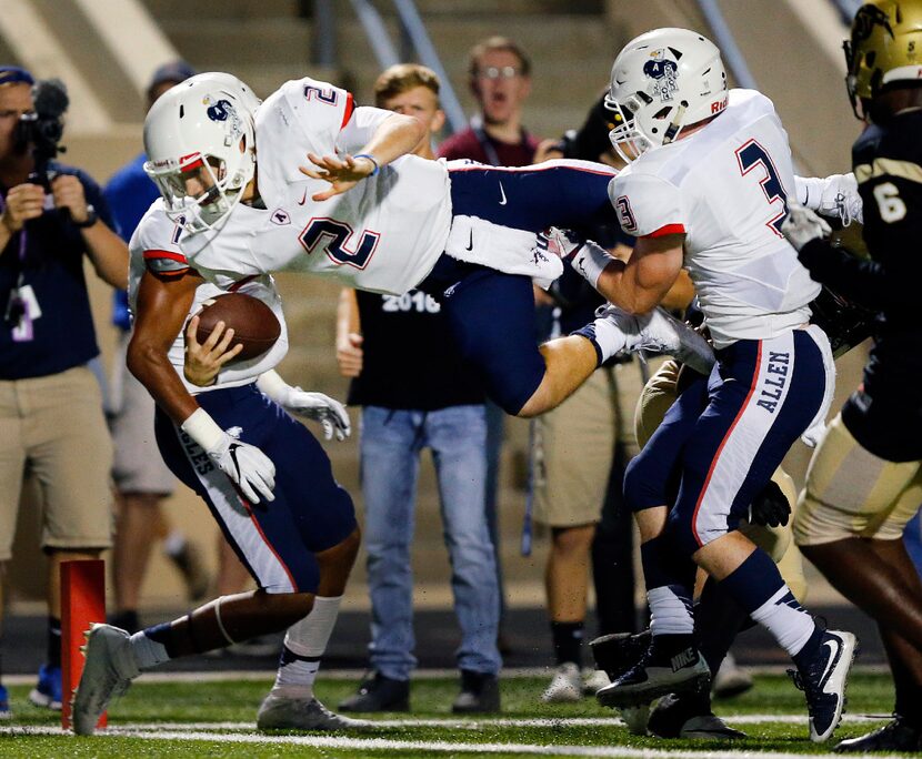 Allen High quarterback Mitchell Jonke (2) dives over Plano East High defensive back Zach...