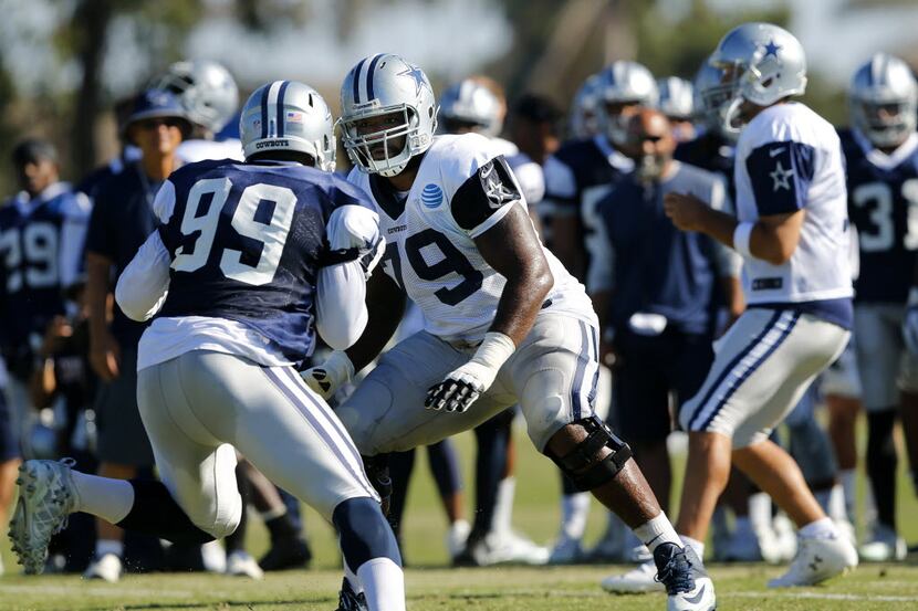Dallas Cowboys offensive tackle Chaz Green (79) and defensive end Ryan Russell (99) square...