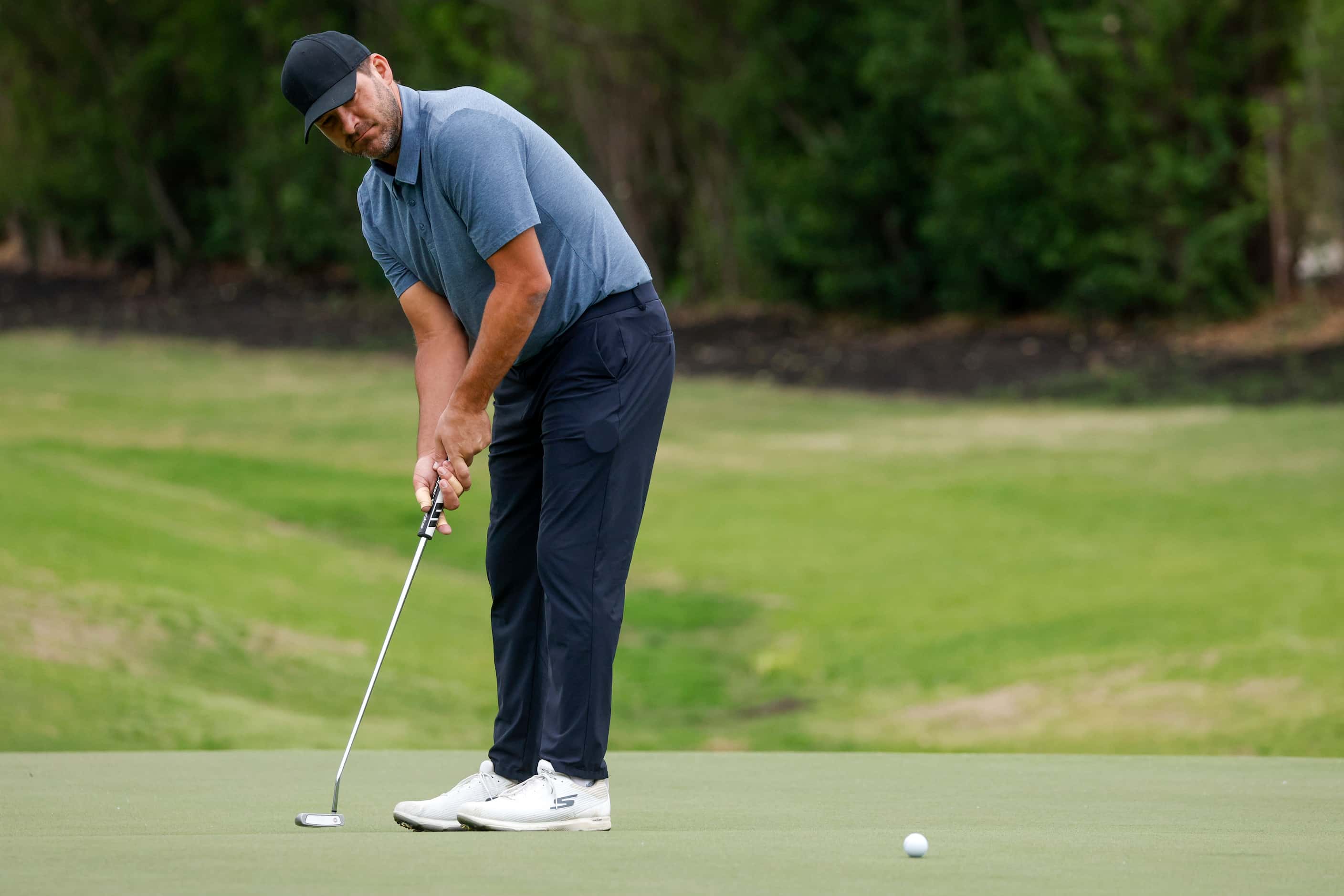 Former Dallas Cowboys quarterback Tony Romo putts on the 17th green during the first round...