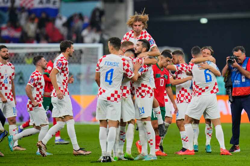 Players of Croatia celebrate at the end of the World Cup third-place playoff soccer match...