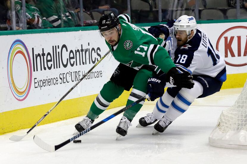 Dallas Stars center Devin Shore (17) attempts to gain control of the puck in front of...