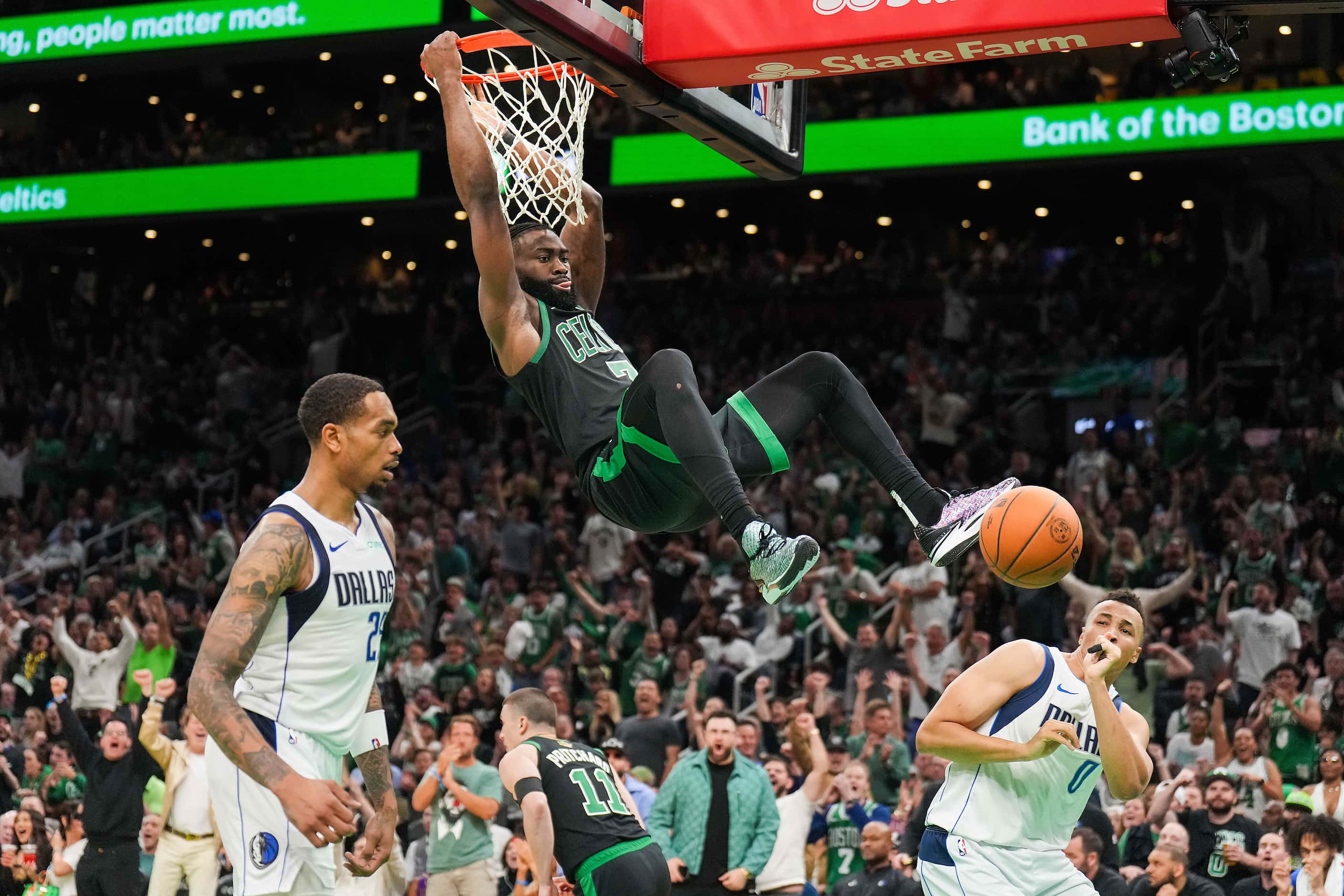 Boston Celtics guard Jaylen Brown (7) dunks the ball past Dallas Mavericks forward P.J....