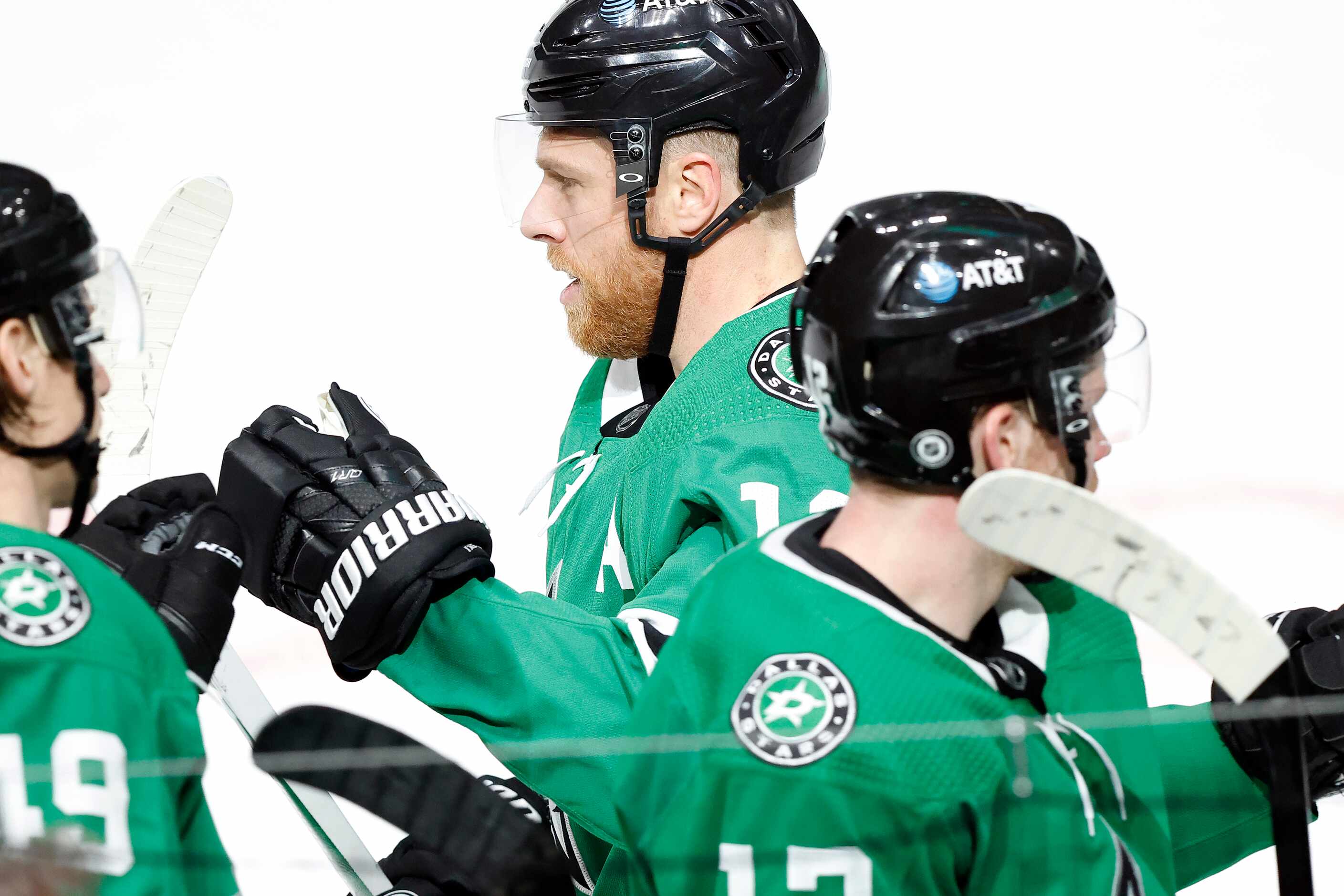 Dallas Stars center Joe Pavelski (16) is congratulated by teammates on the bench after...