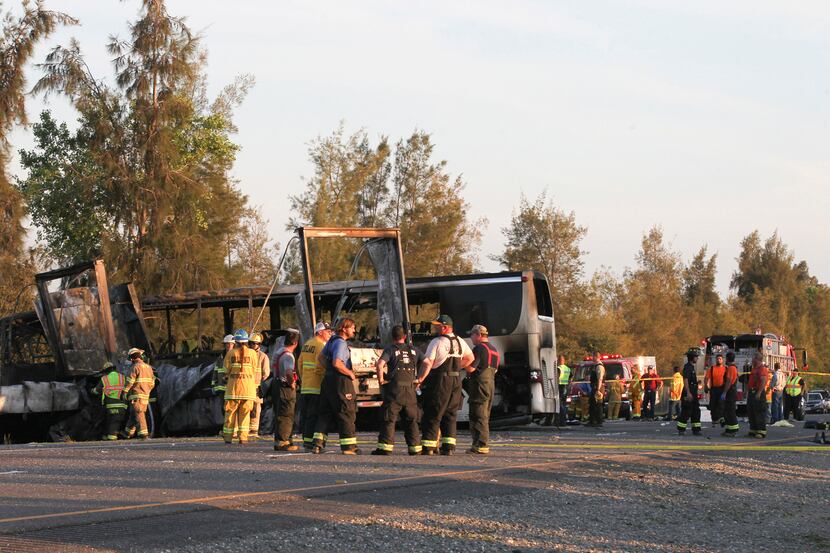 Rescue workers, police and firefighters work the accident in northern California in which...