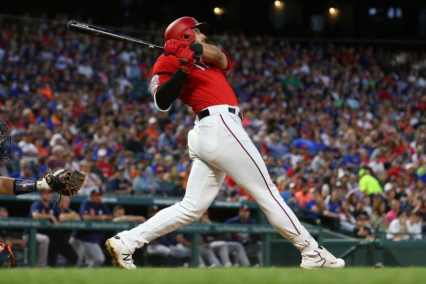 ARLINGTON, TEXAS - APRIL 20: Joey Gallo #13 of the Texas Rangers watches his home run shot...