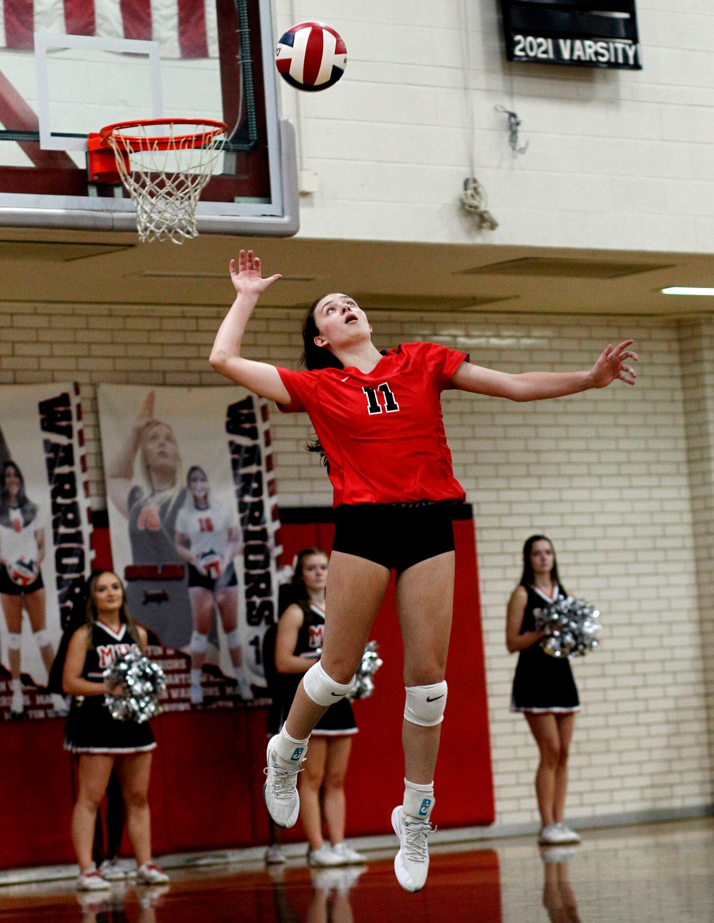 Arlington Martin's Madeline Hopp (11) serves during the 3rd set of the Warriors' straight...