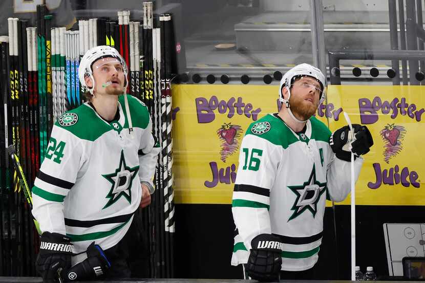 Dallas Stars center Roope Hintz (24) and center Joe Pavelski (16) watch the replay after...