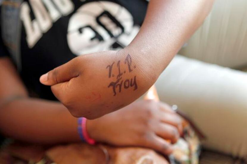 
Jessika Hawkins, 14, who was close to victim Troy Causey Jr., shows off what a friend wrote...