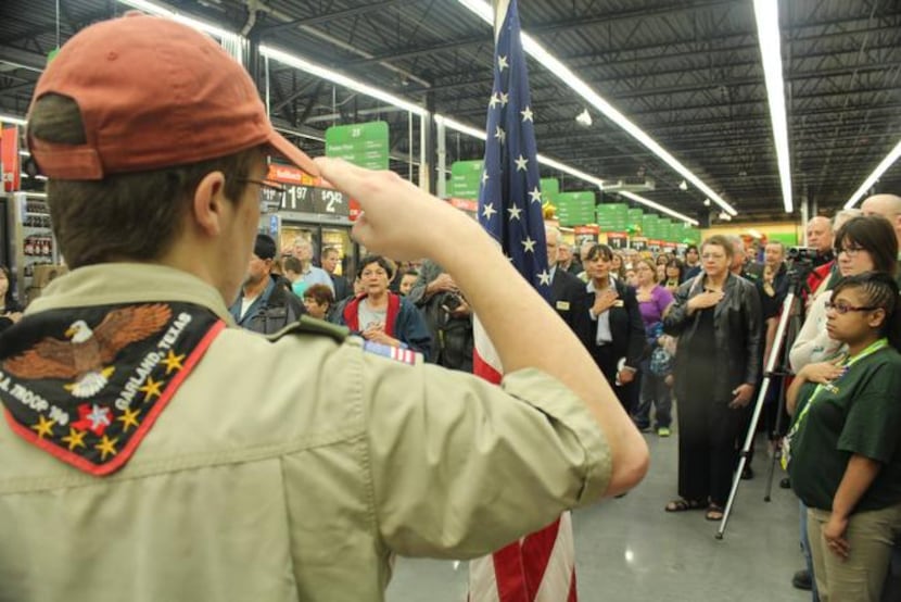 
Chris Freeland of Boy Scout Troop 100 salutes the American flag during the grand opening of...