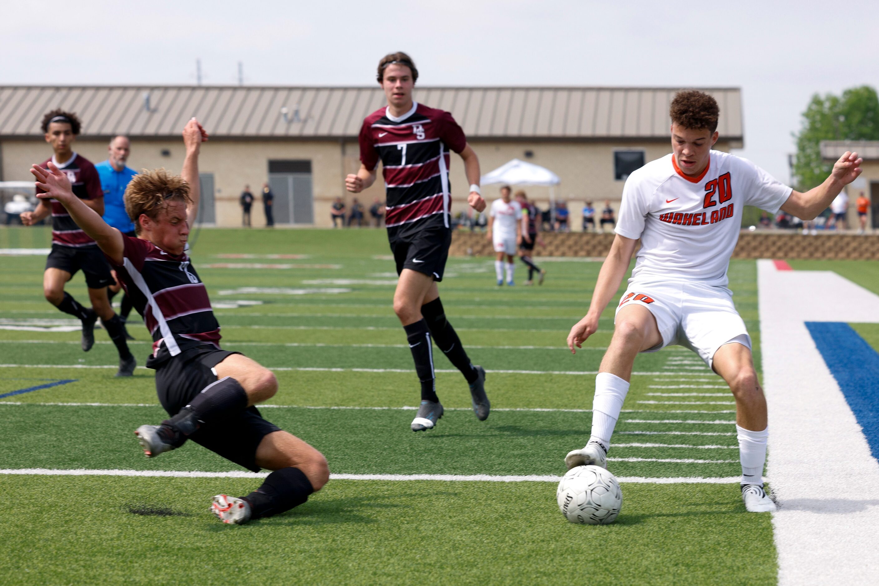 Dripping Springs defender Ian Driggers (13) slide tackles Frisco Wakeland midfielder Micah...