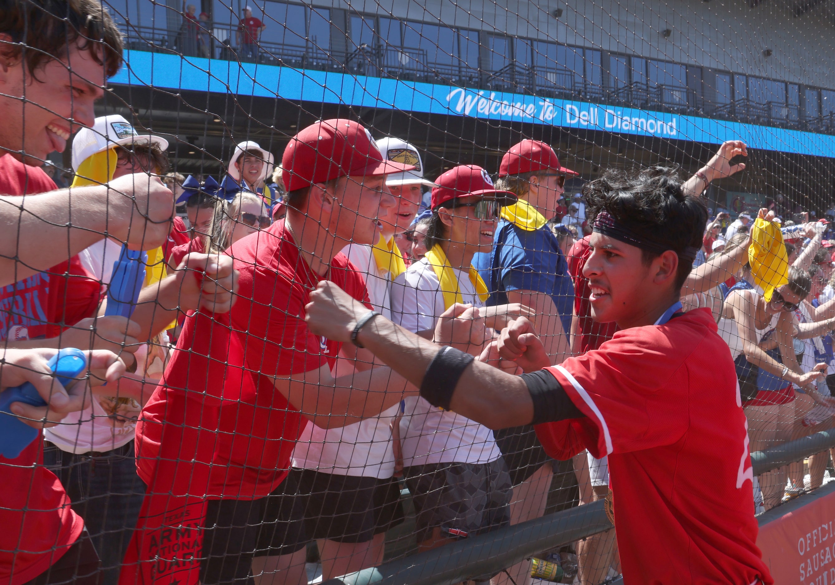 Grapevine catcher Gianni Corral (24), right, fist bumps fans after the Mustangs' 6-5 victory...