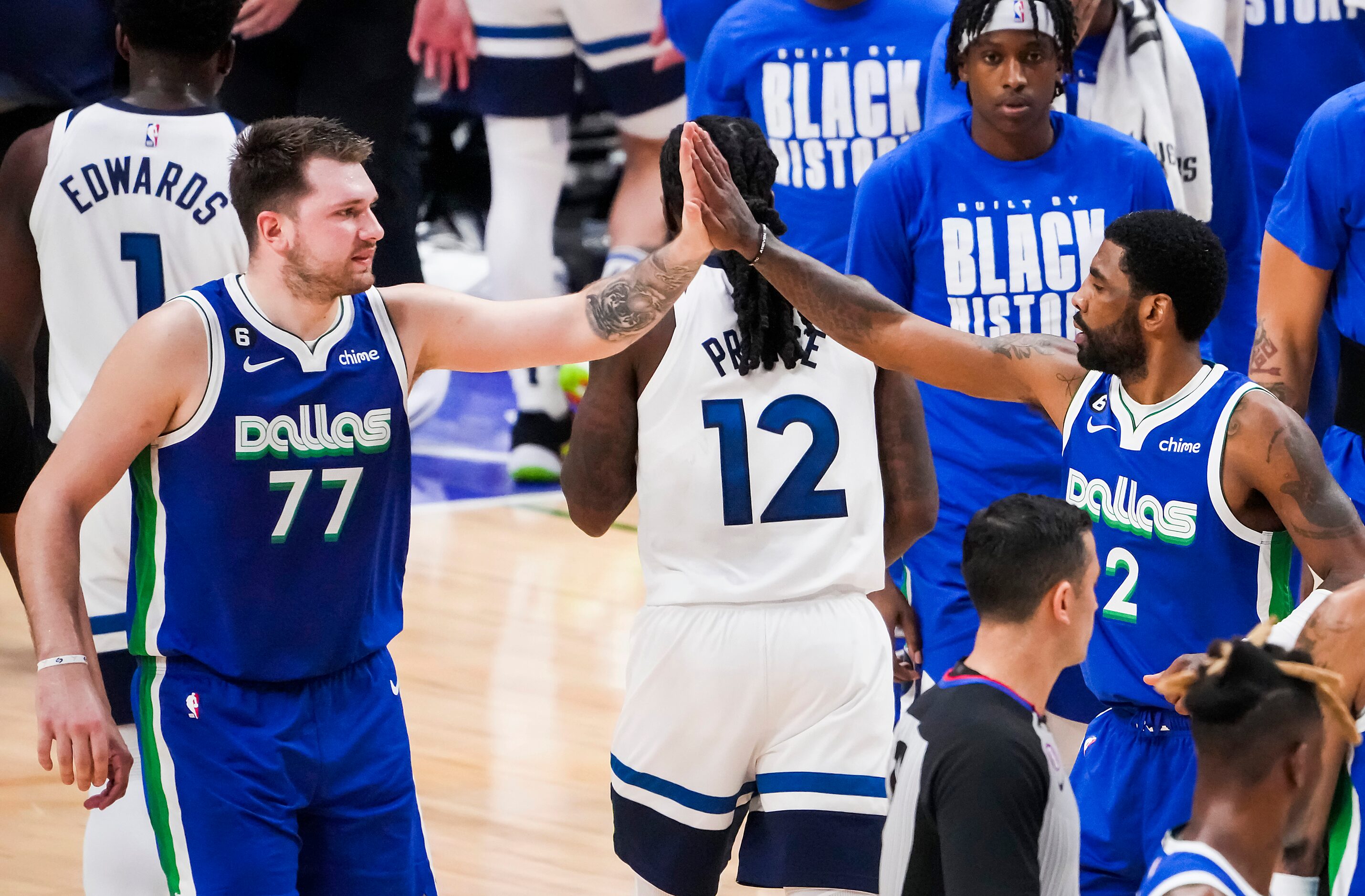 Dallas Mavericks guard Luka Doncic (77) high fives guard Kyrie Irving (2) during the first...