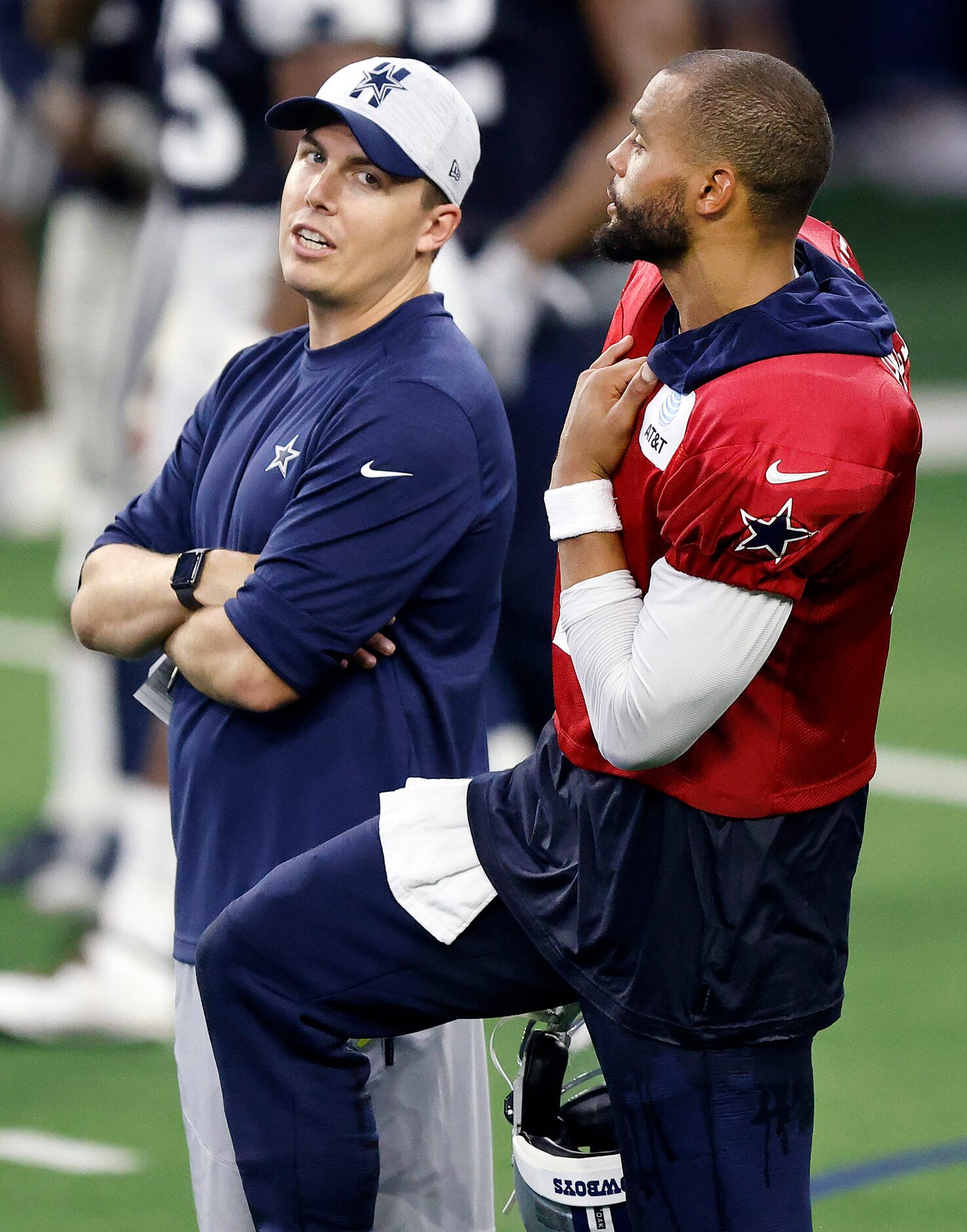 Dallas Cowboys offensive coordinator Kellen Moore visits with quarterback Dak Prescott (4)...