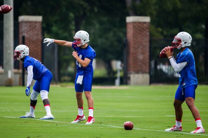 Quarterbacks work out during SMU's first football practice of the season on Tuesday, August...