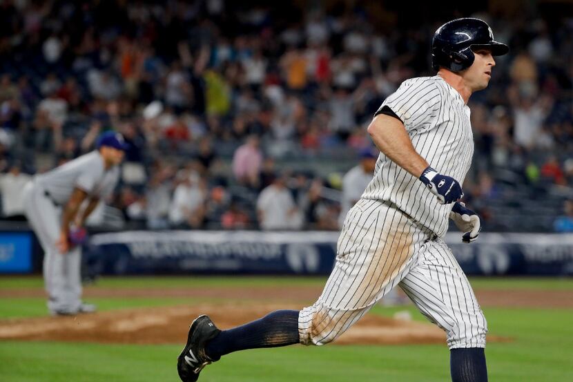 New York Yankees' Brett Gardner rounds first base after hitting a solo home run to tie the...