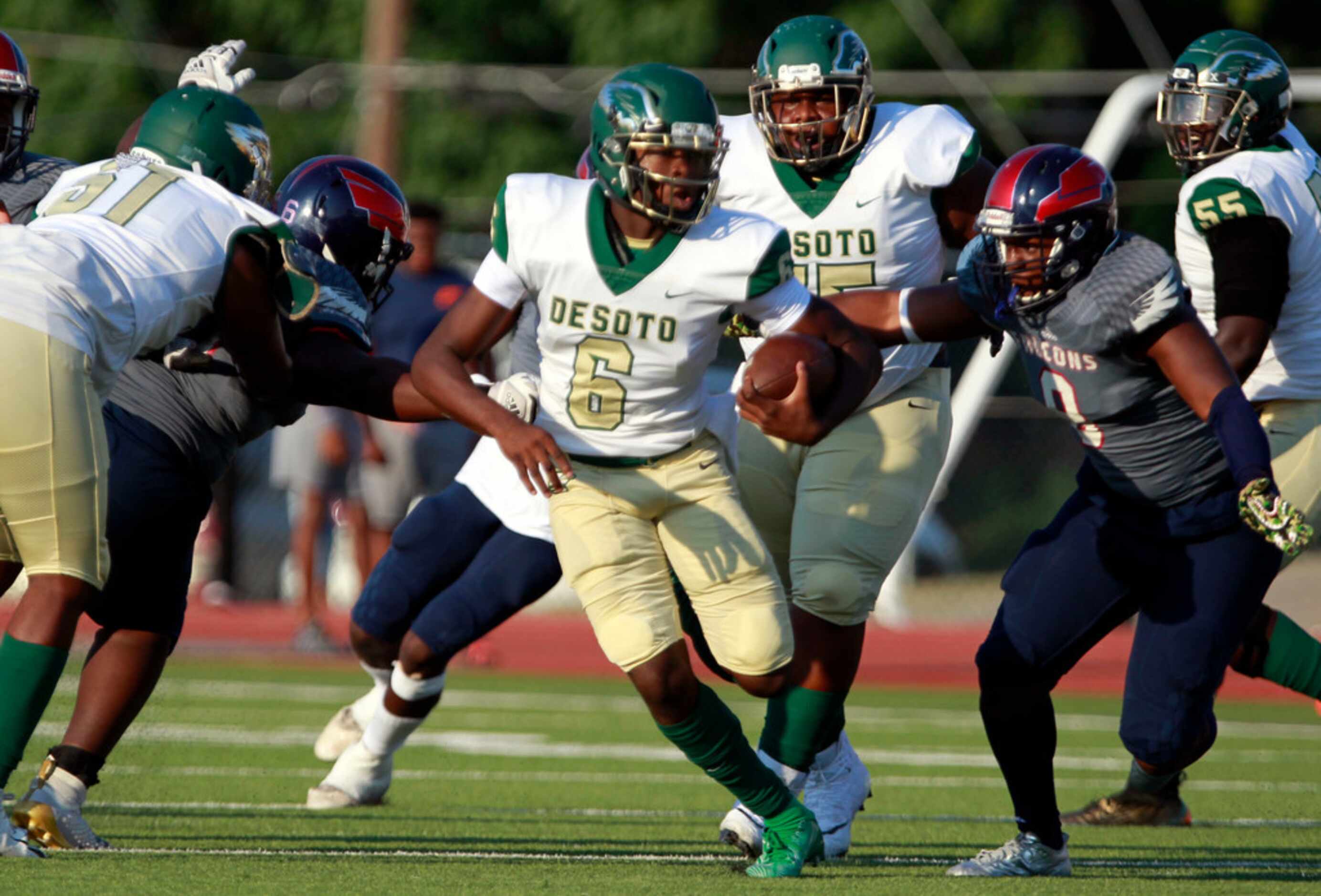 Desoto QB Samari Coilier (6) scrambles for a couple of yards under pressure by the Bishop...