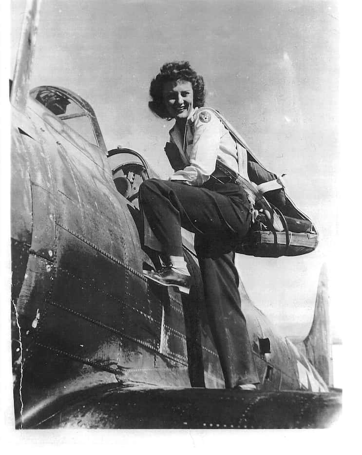 Muriel "Mimi" Lindstrom Segall climbs into a plane during her service a Women Airforce...