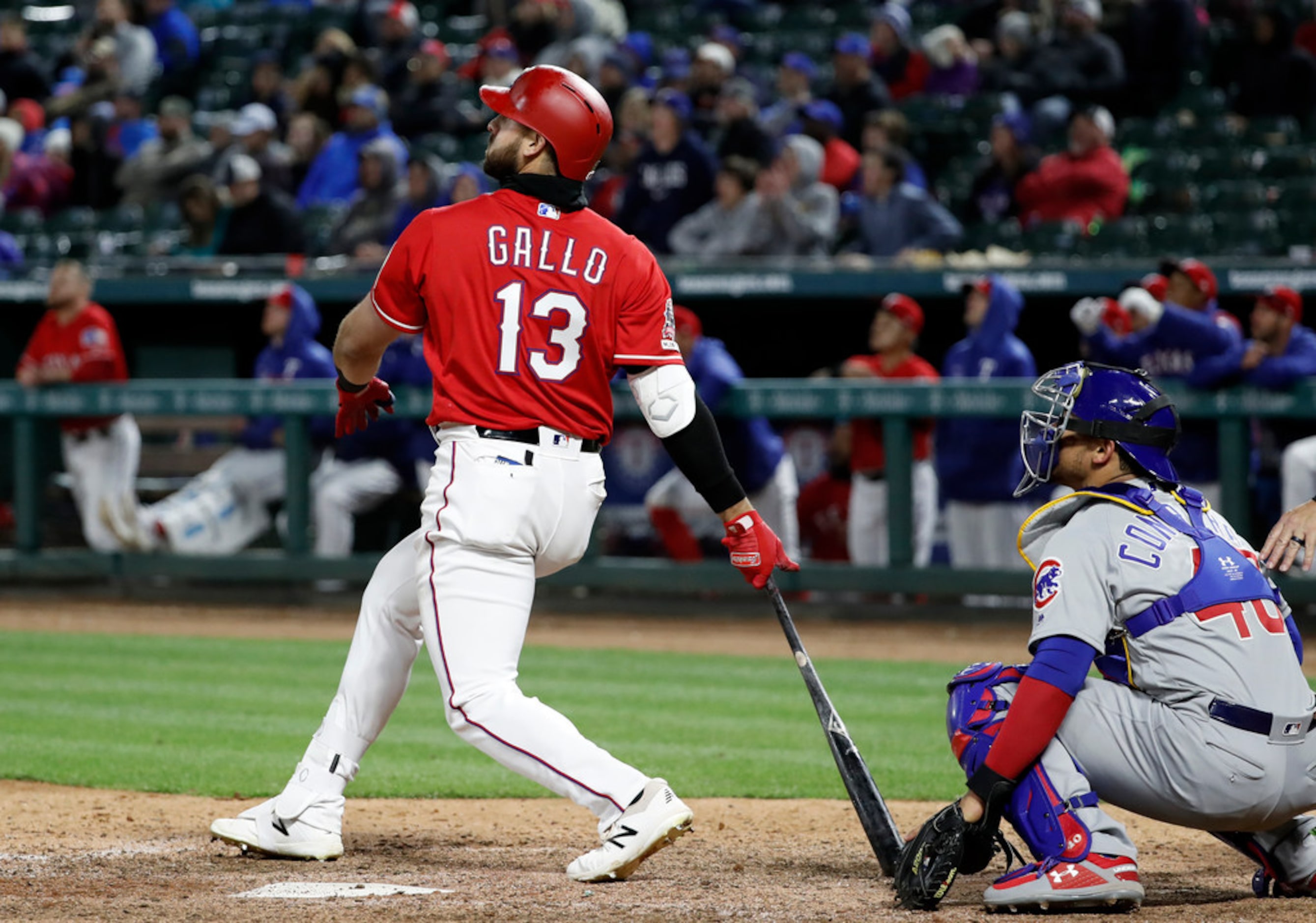 Texas Rangers' Joey Gallo (13) and Chicago Cubs catcher Willson Contreras (40) watch Gallo's...