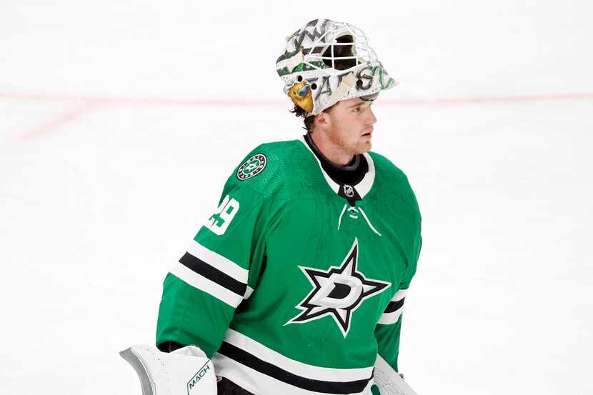 Dallas Stars goaltender Jake Oettinger (29) skates to the bench during the third period in...