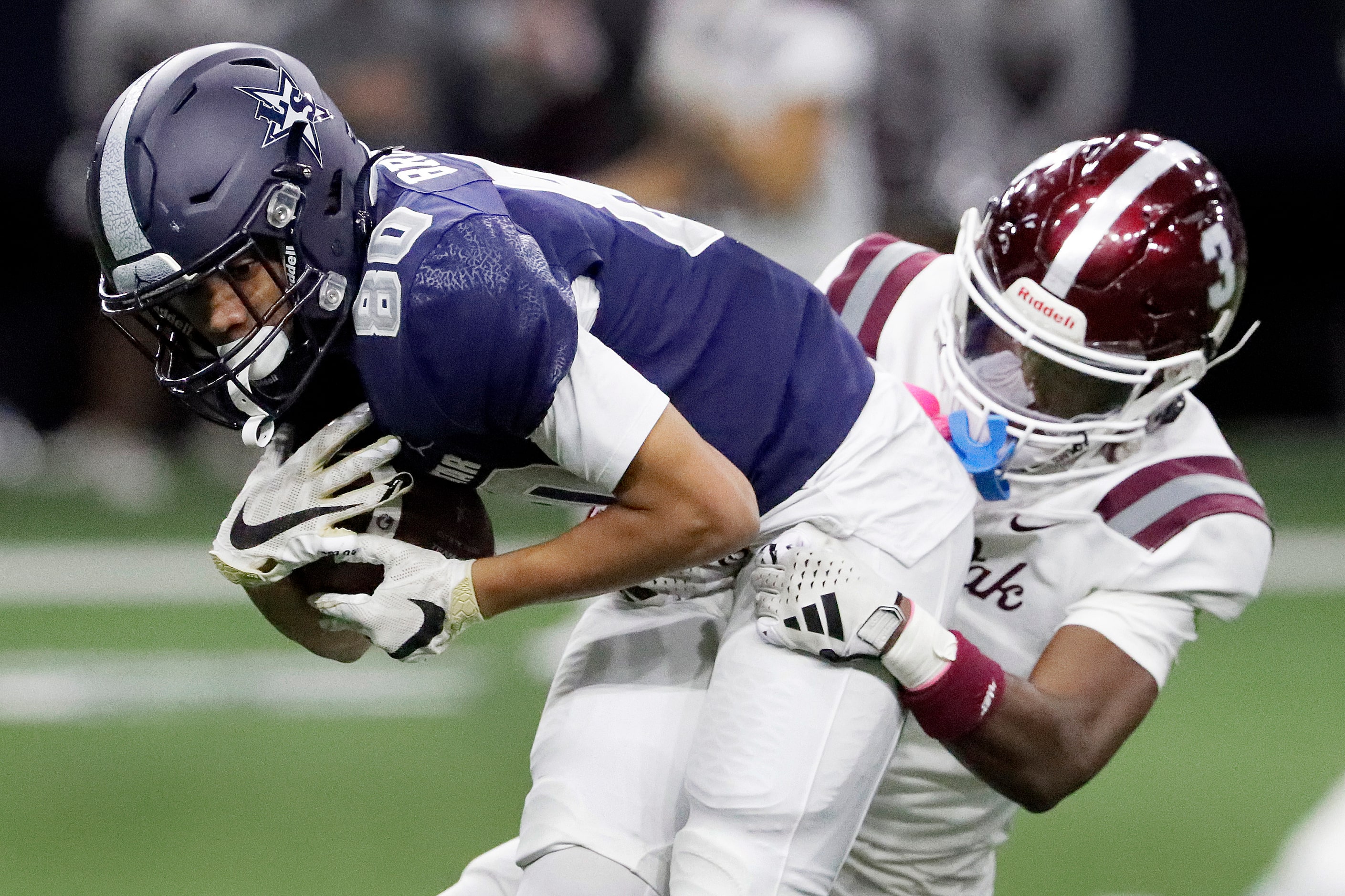 Lone Star High School wide receiver Logan Brown (80) is brought down by Red Oak High School...